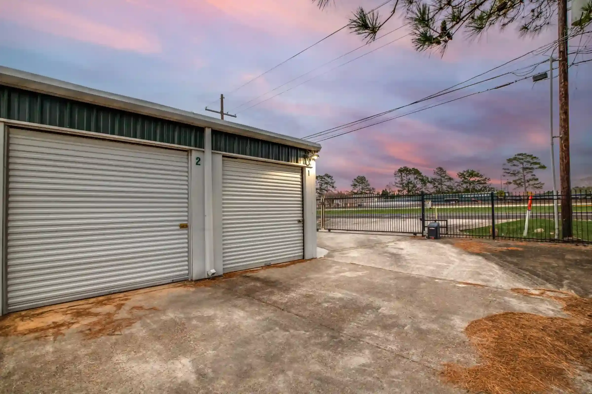 fenced storage facility with roll up doors and drive up access
