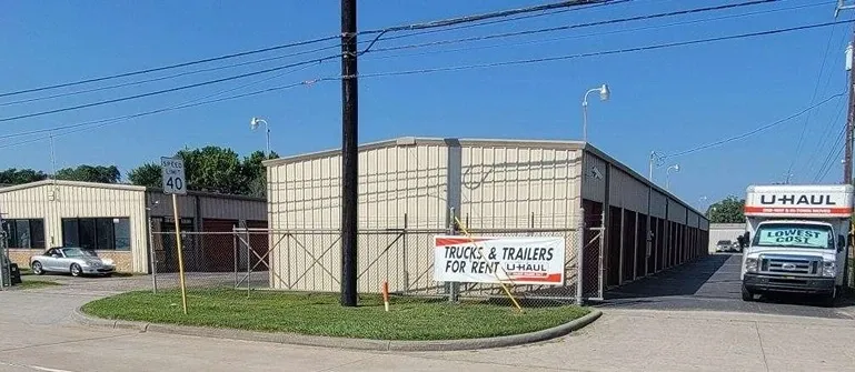 truck trailer for rent sign next to a uhaul truck