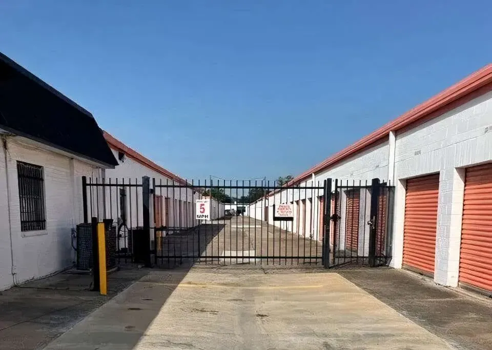 row of self storage units with drive up and secure gated entry
