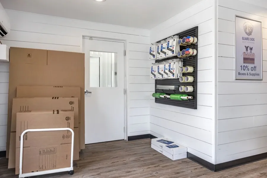 Interior of an office space with moving supplies hanging on a peg board.