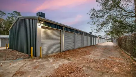 fenced storage facility with roll up doors and drive up access