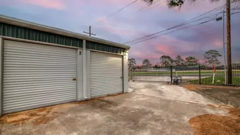 fenced storage facility with roll up doors and drive up access