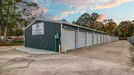 fenced storage facility with roll up doors and drive up access