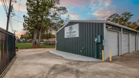 fenced storage facility with roll up doors and drive up access