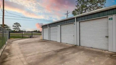 fenced storage facility with roll up doors and drive up access