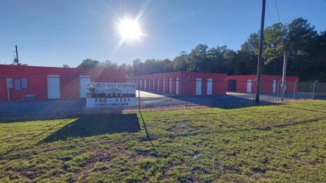 row of self storage units with drive up fenced around