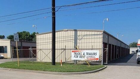 truck trailer for rent sign next to a uhaul truck