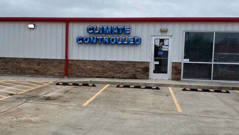 parking lot at self storage facility with climate controlled sign